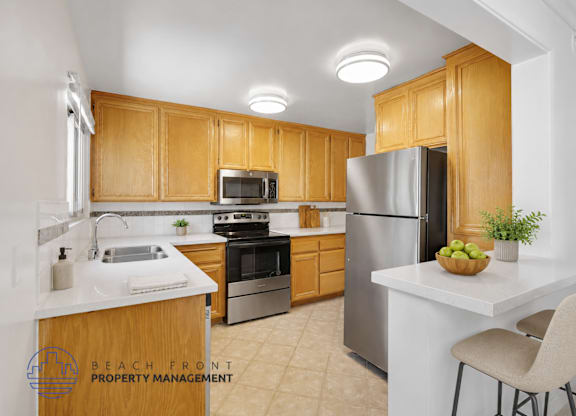 A kitchen with wooden cabinets and stainless steel appliances.