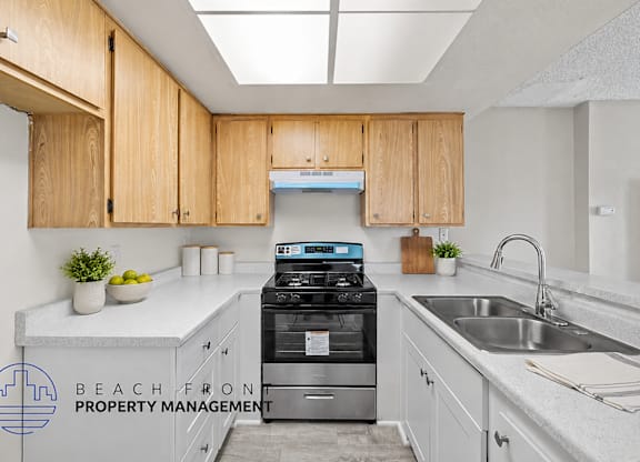 A kitchen with wooden cabinets and a stove top oven.