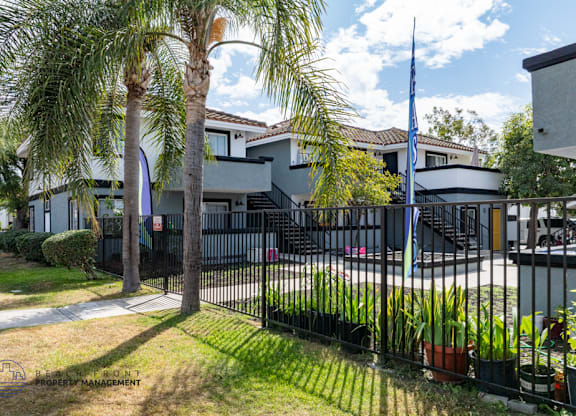 A building with a black fence and a flag on top.