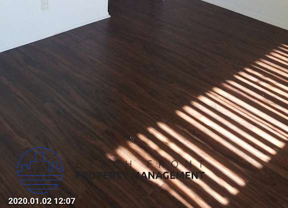 an empty room with wooden floors and a closet