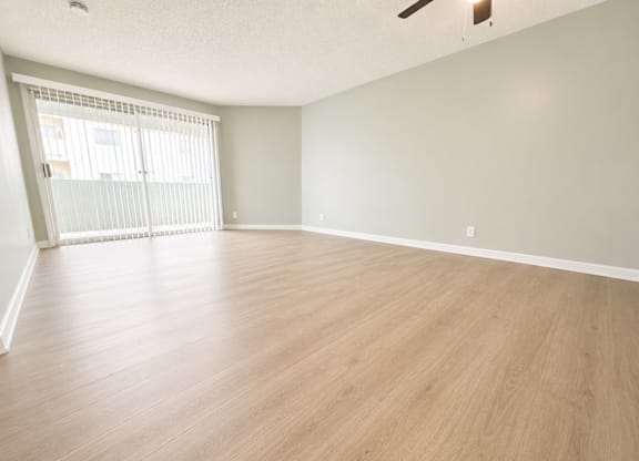 Empty room with wooden floor and white walls.
