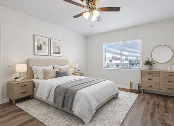 A bedroom with a bed, dresser, and window.
