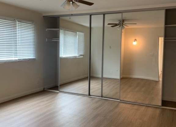 A white room with a wooden floor and a white ceiling.