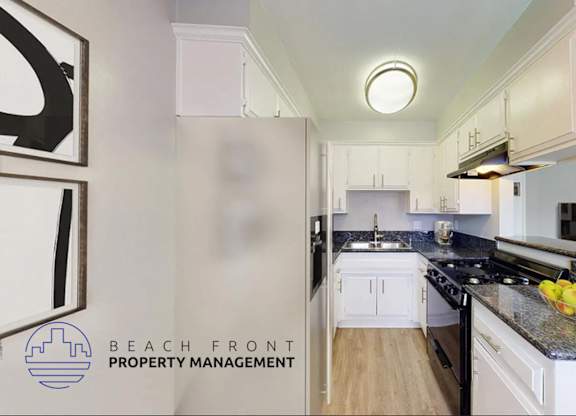 A kitchen with a counter top and a bowl of fruit on it.