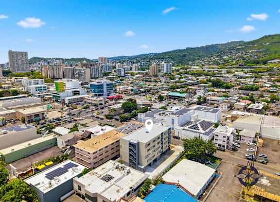 A cityscape with buildings of various sizes and a clear blue sky above.