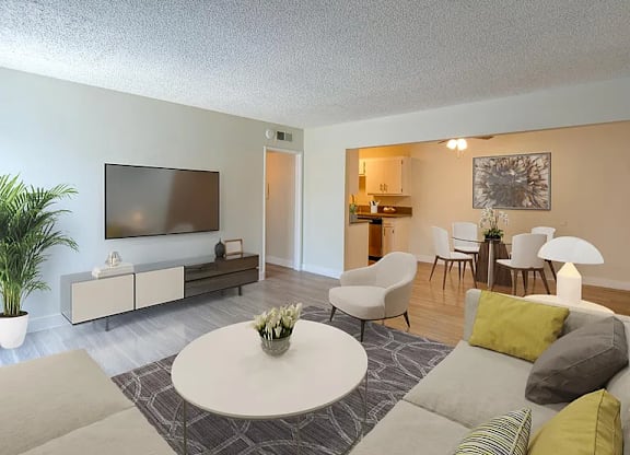 A living room with a white coffee table and grey couches.