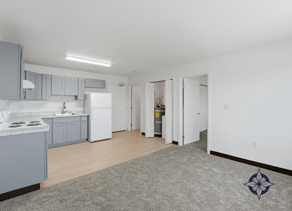 A kitchen with a white fridge and a grey rug.