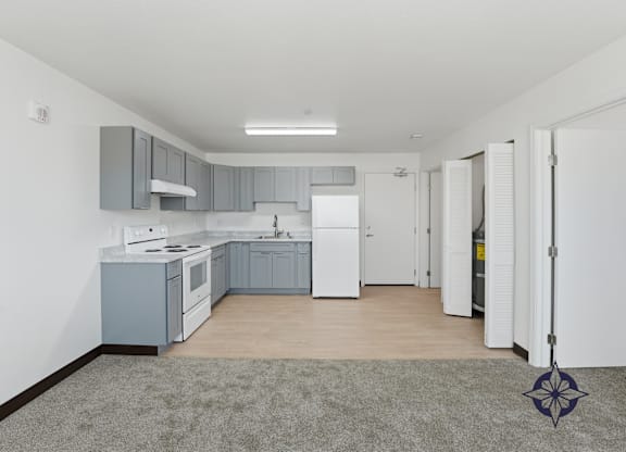 A kitchen with a white fridge and a white stove.