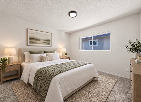 A bedroom with a large bed and a painting on the wall.
