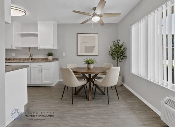A dining room with a table set for four.
