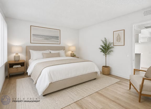 A bedroom with a large bed, a small plant, and a chair.