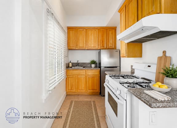 A kitchen with wooden cabinets and white appliances.
