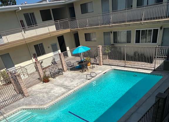 A small pool with a fence around it.