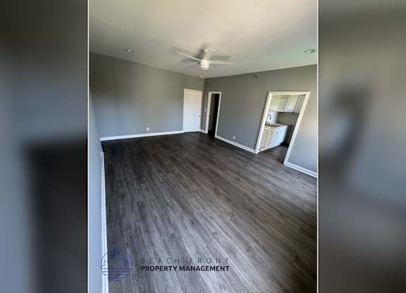 A spacious room with wooden flooring and a ceiling fan is on the market.