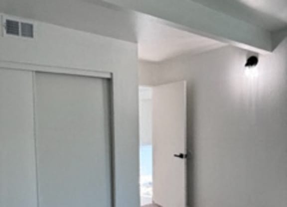 A room with a sliding door and a carpeted floor.