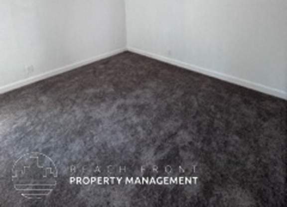 A room with a carpeted floor and white walls.