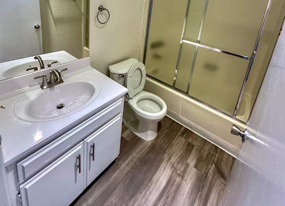 a bathroom with a sink toilet and shower