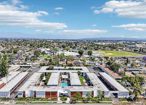 A large industrial complex with multiple buildings and a parking lot in the foreground.