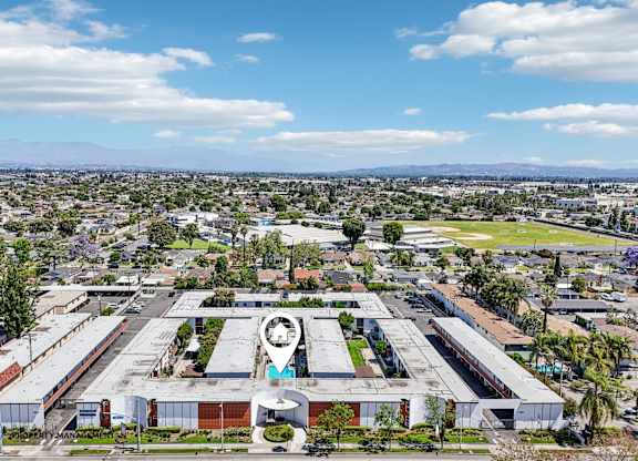 A large industrial building with a circular logo on the front.