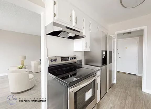 A modern kitchen with stainless steel appliances and white cabinets.