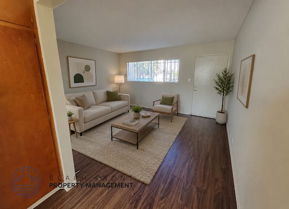 A living room with a couch, chair, and coffee table.