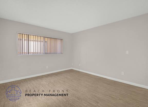 A room with a logo of Beach Front Property Management on the floor.