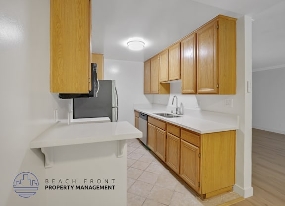 A kitchen with wooden cabinets and a white countertop.