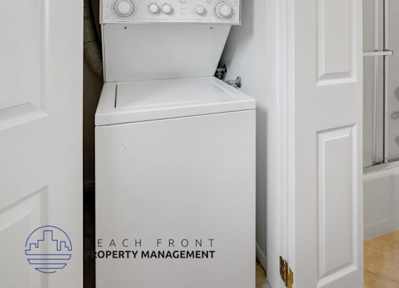 A white oven is built into a white cabinet in a white room.