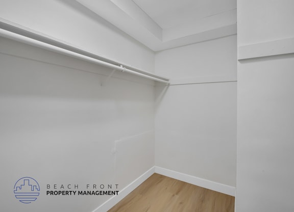 A white wall with a logo that says "Beach Front Property Management".