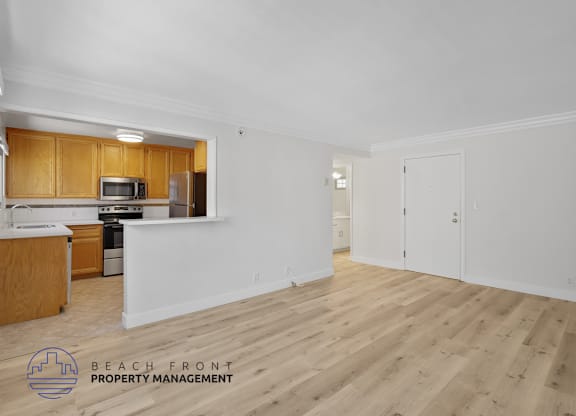 A kitchen with wooden cabinets and a white countertop is shown in the image.