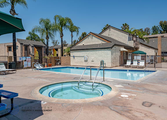 A pool with a slide in the middle of it.