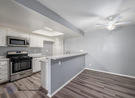 A kitchen with a stove top oven and a microwave.