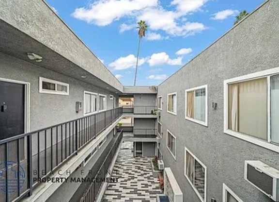 A balcony with a black railing and a tiled floor.