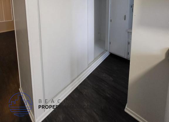 a white wall with a sliding door in a room