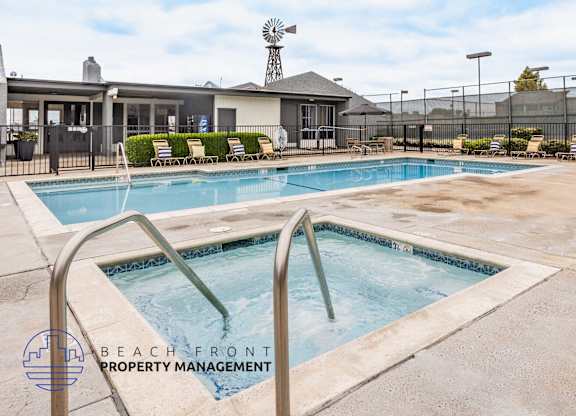 A pool with a slide and a logo for Beach Front Property Management.