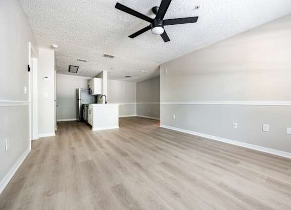 A room with a ceiling fan and light fixture.