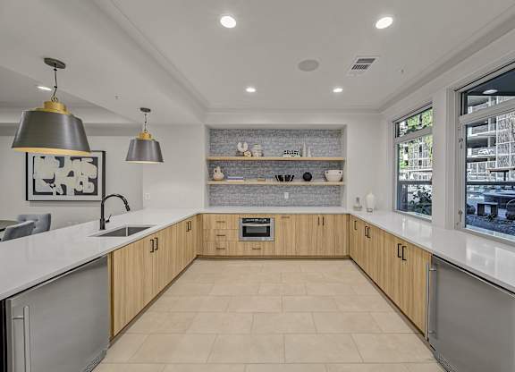 A modern kitchen with wooden cabinets and a large island.