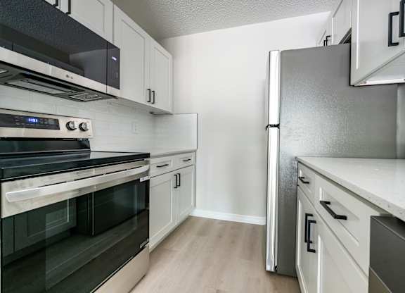 A kitchen with a stove, oven, and refrigerator.