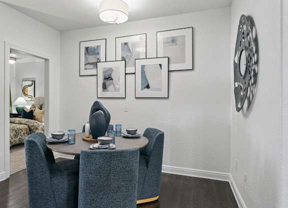 A dining room with a table set for four.