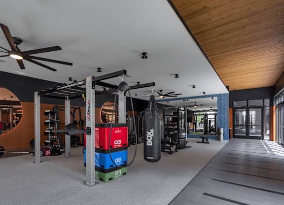 a home gym with a red and blue machine in the middle of the room