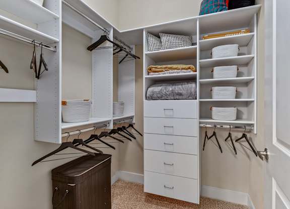 A white closet with drawers and shelves.