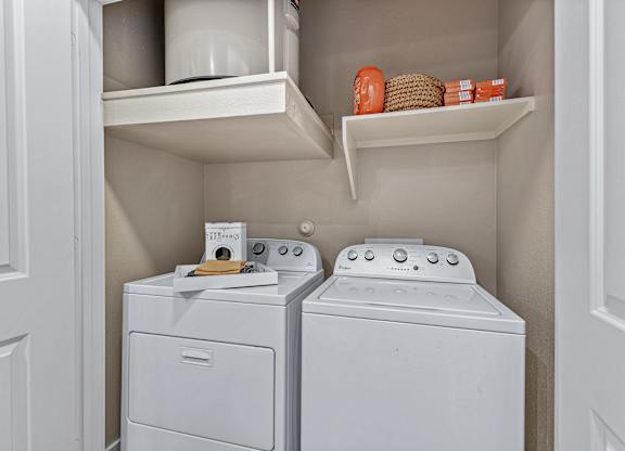 A small laundry room with a washer and dryer.