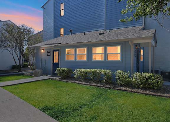 A house with a grey roof and a blue wall.