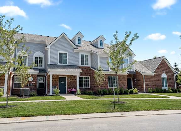 a large brick house with a street in front of it