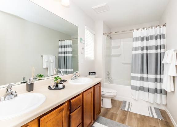 A bathroom with a white sink and a toilet.