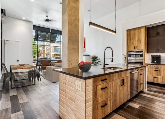 a kitchen with wooden cabinets and a large island with a sink
