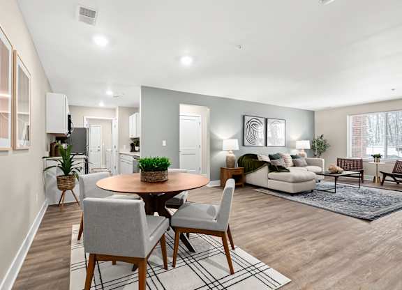 an open living room and dining room with a table and chairs