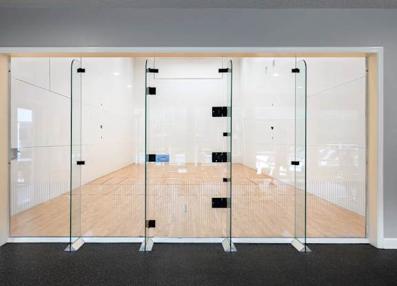 A room with a wooden floor and glass walls.