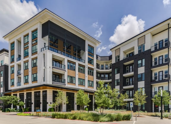 a large apartment building with a street in front of it
