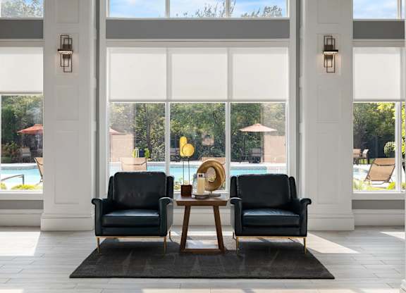 Two black chairs are placed in front of a table with a yellow object on it.